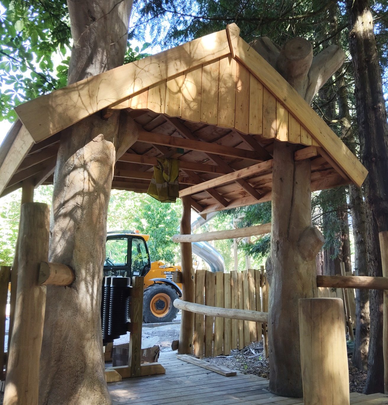 Artificial rockwork tree trunks, supporting a hut at Birdworld.