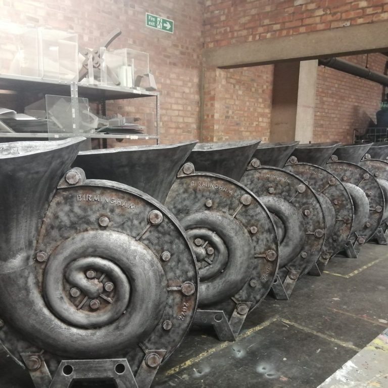 Row of oversized industrial looking car horns that were made of foam and used as cosutumes at the Commonwealth Games Opening Ceremony